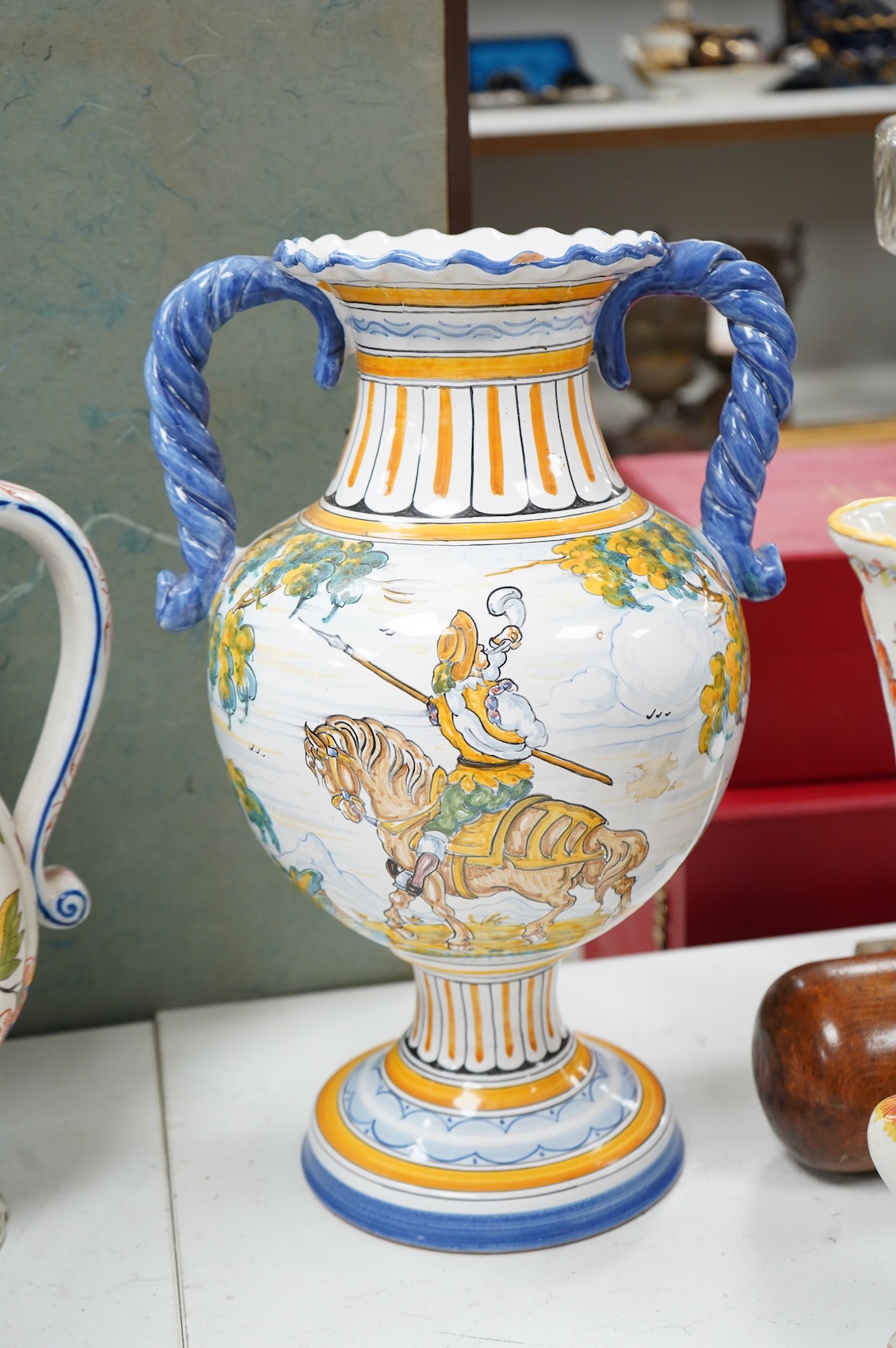 Two large French faience jugs and a vase, and a Talavera twin handled urn/vase, 44cm high